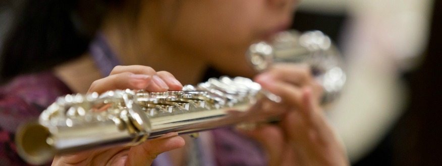 student playing the flute