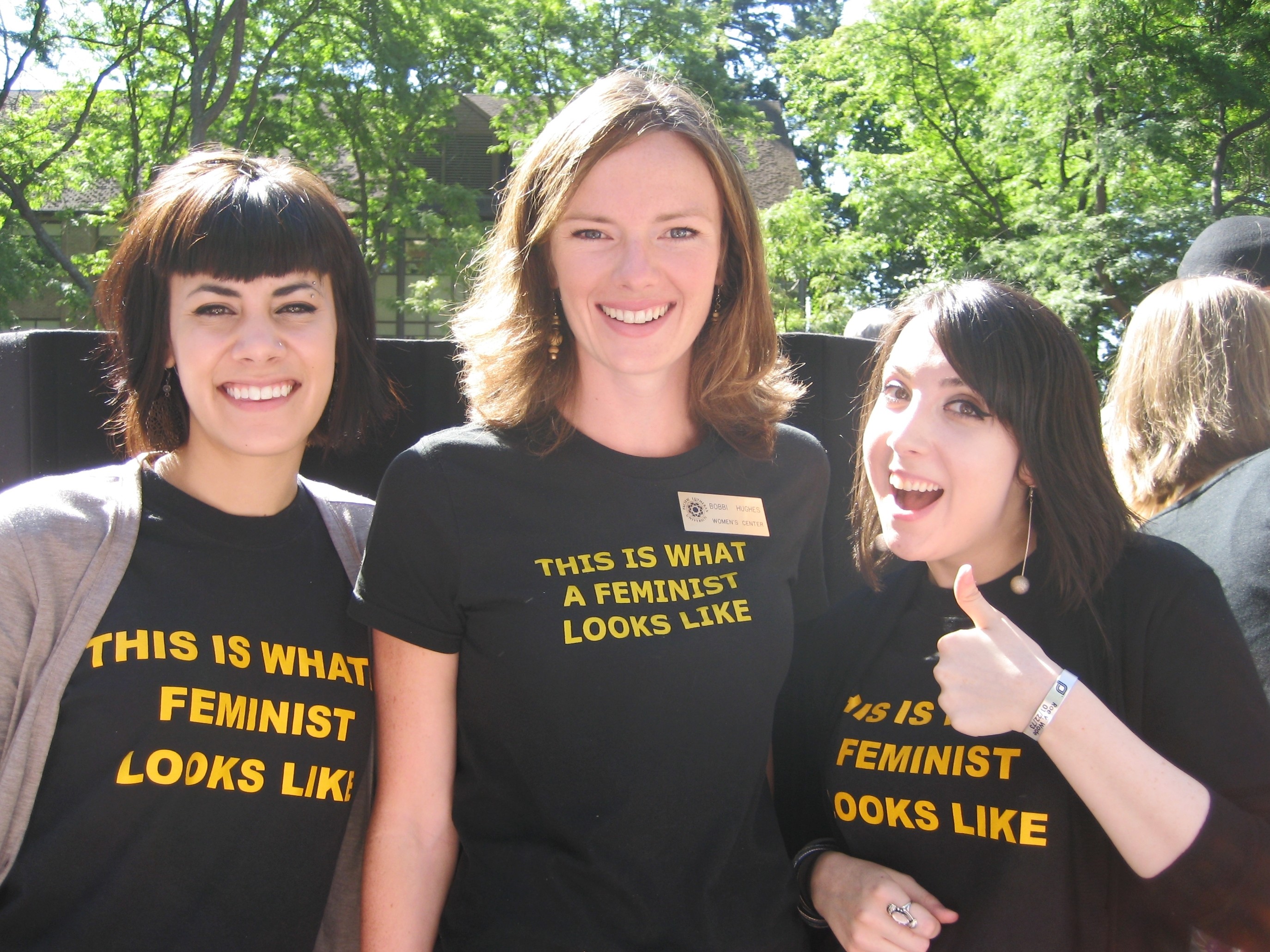 Feminist Student Union - 3 women smiling for the camera