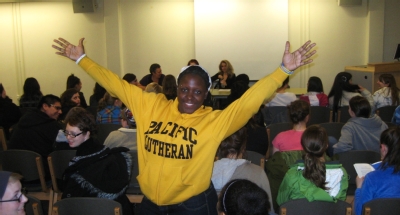 student waving at a sexpositive conference