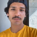 Luis Reyes in a yellow PLU shirt