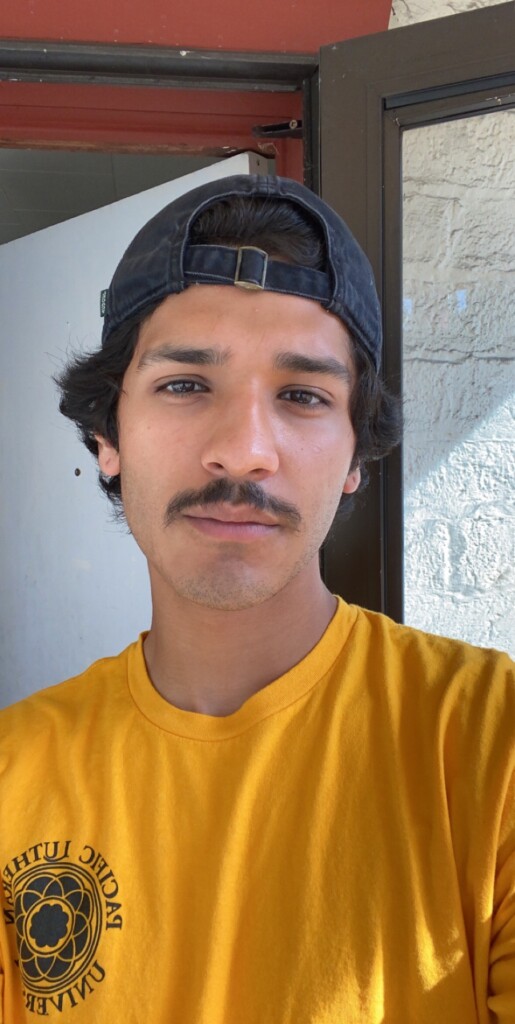 Luis Reyes in a yellow PLU shirt