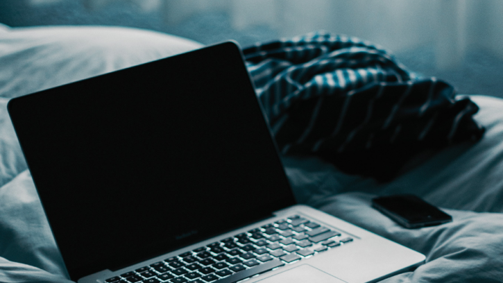 A computer on a bed