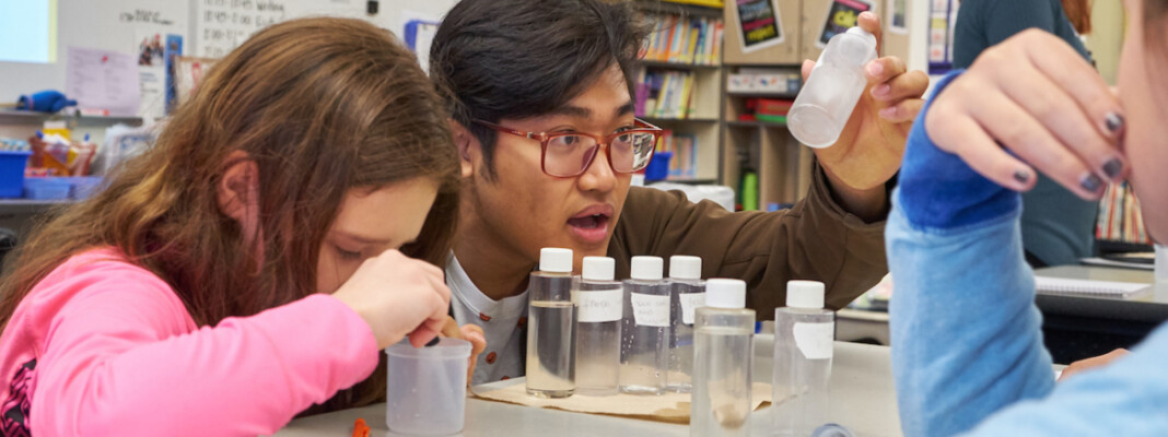 PLU student Jimmy Aung leads a science class.
