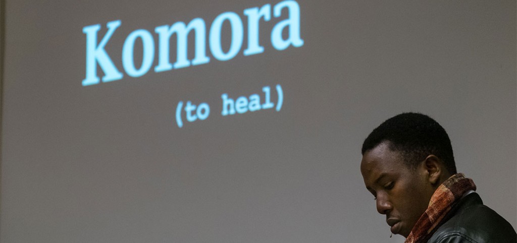 Emmanuel Habimana, filmmaker and survivor of the 1994 Rwandan genocide, speaks at PLU in from of a projection of the word Komora, which means to heal.