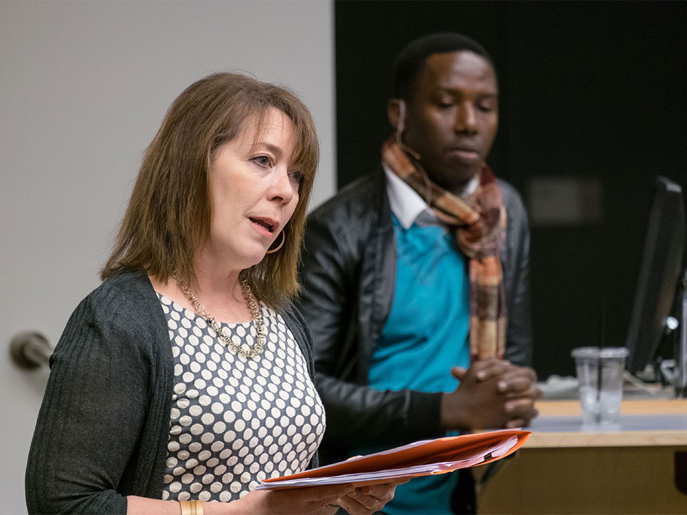 Director of Holocaust and Genocide Studies Programs, Kirsten Christensen, introduces Emmanuel Habimana, filmmaker and survivor of the 1994 Rwandan genocide. (Photo: John Froschauer/PLU)