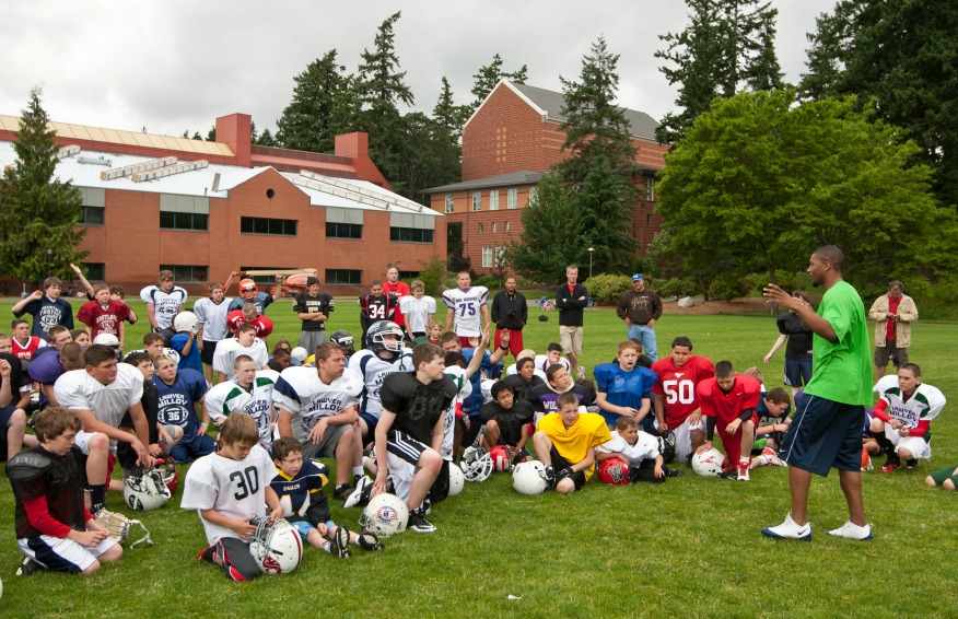 Seahawks' Deon Butler talks to a group of young players at the Lawyer Milloy Football Camp held at PLU on Wednesday, June 29, 2011.