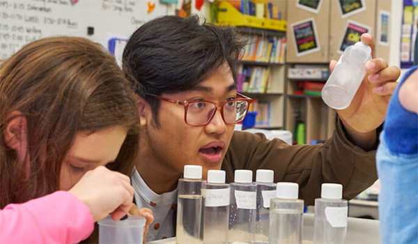 A STEM student holding a plastic bottle