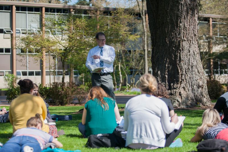 Professor Halvorson teaching outside on upper campus during Spring term.