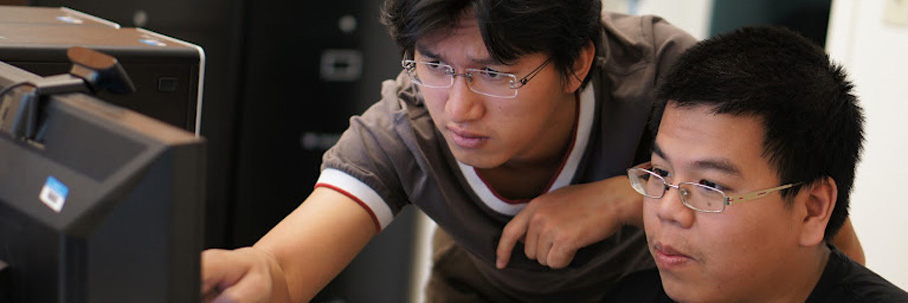 2 students looking at computer monitor