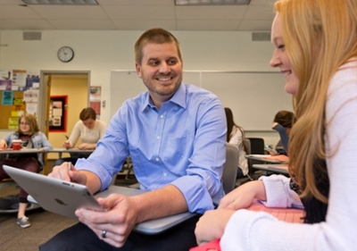 Seth Dowland and student reviewing grading annotations on an iPad. (PLU Photo/John Froschauer)