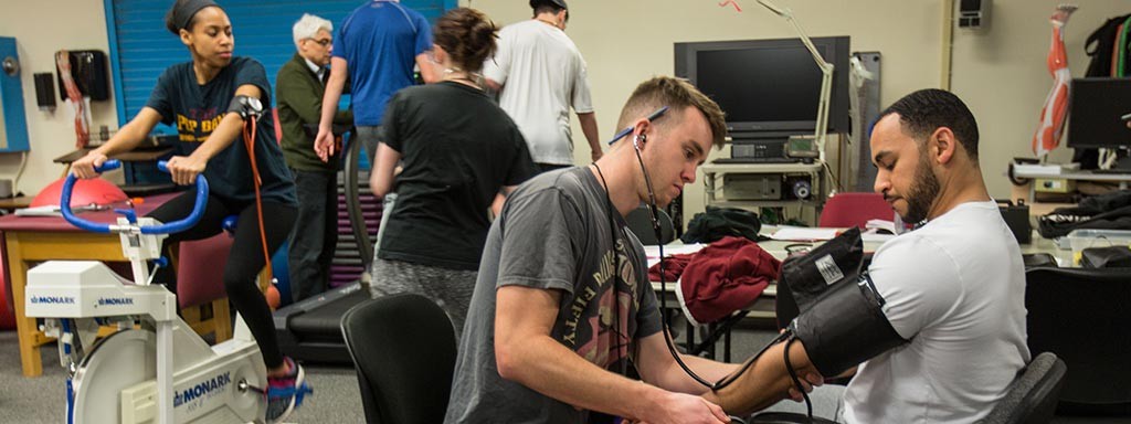 Kinesiology students checking blood pressure.