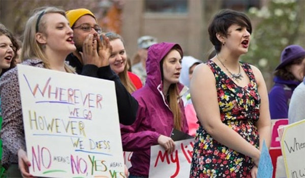 Women protesting their rights and holding signs