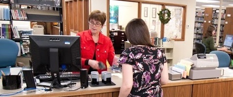 Circulation desk with Ann Dodge and student
