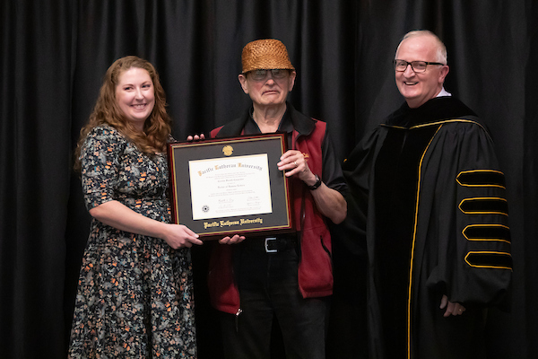 20240926_SB_Lutheran-Studies-Conference_051 Cecilia Svinth Carpenter’s granddaughter accepts her grandmother’s honorary degree during the Lutheran Studies Conference, Thursday, Sept. 26, 2024, at PLU. (PLU Photo / Sy Bean)