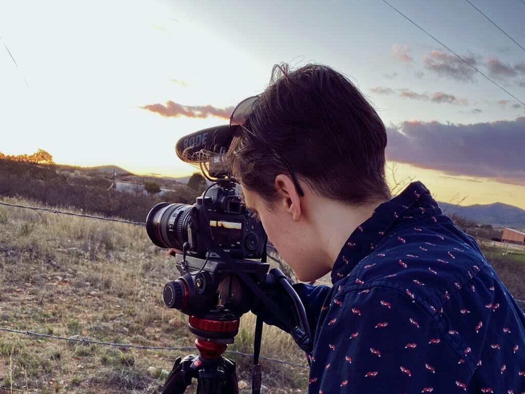 Co-director of photography filming part of the border fence at sunset