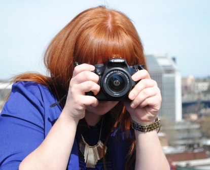 Student holding camera