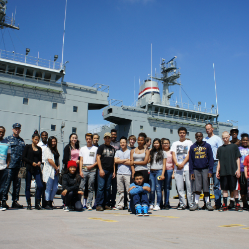 students posing on deck of ship