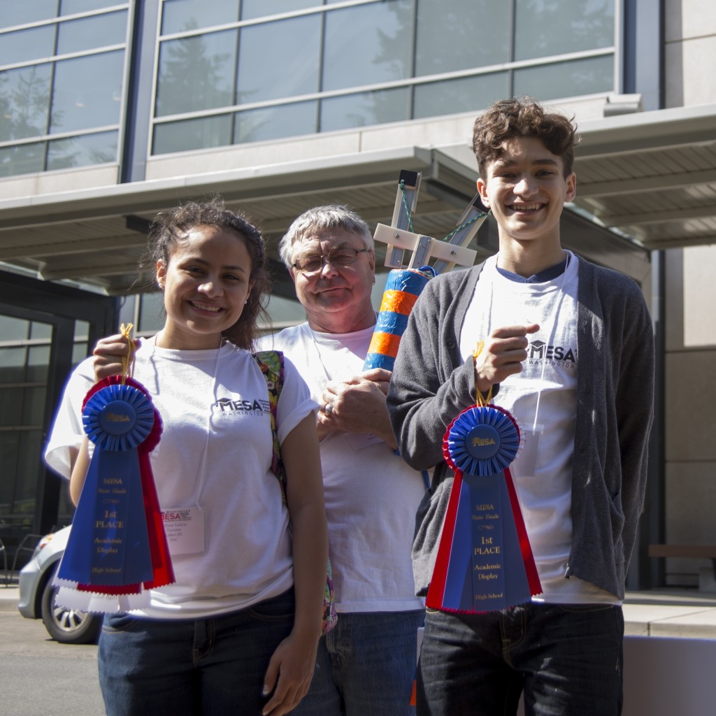 Two students posing with 1st place ribbons