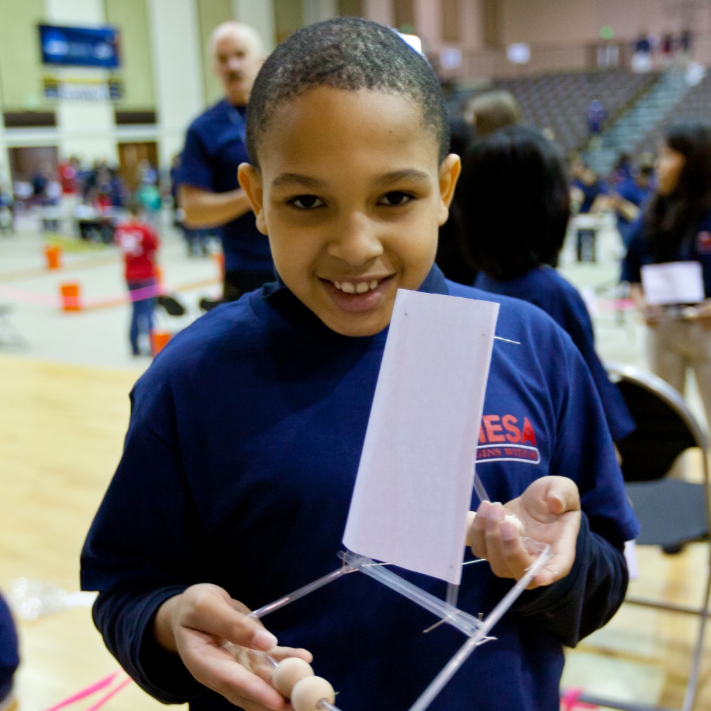 Student showing straw project on MESA day