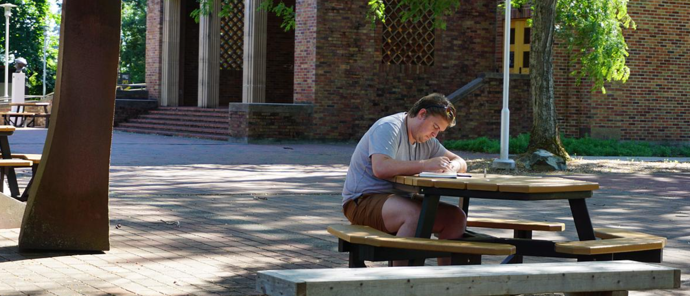 An MFA student writing during the summer residency.