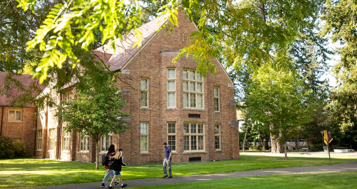Students walking across campus in front of Xavier Hall.