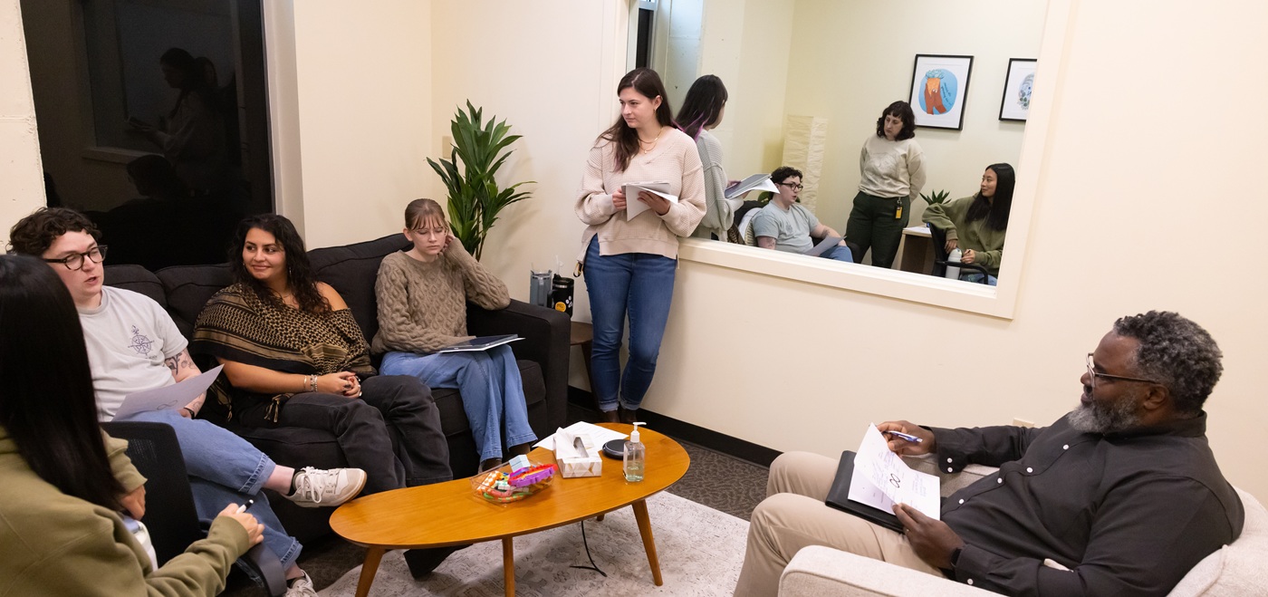 MFT Banner 01 MFT students and faculty sit in a brightly lit therapy room in PLU's Couple & Family Therapy Center