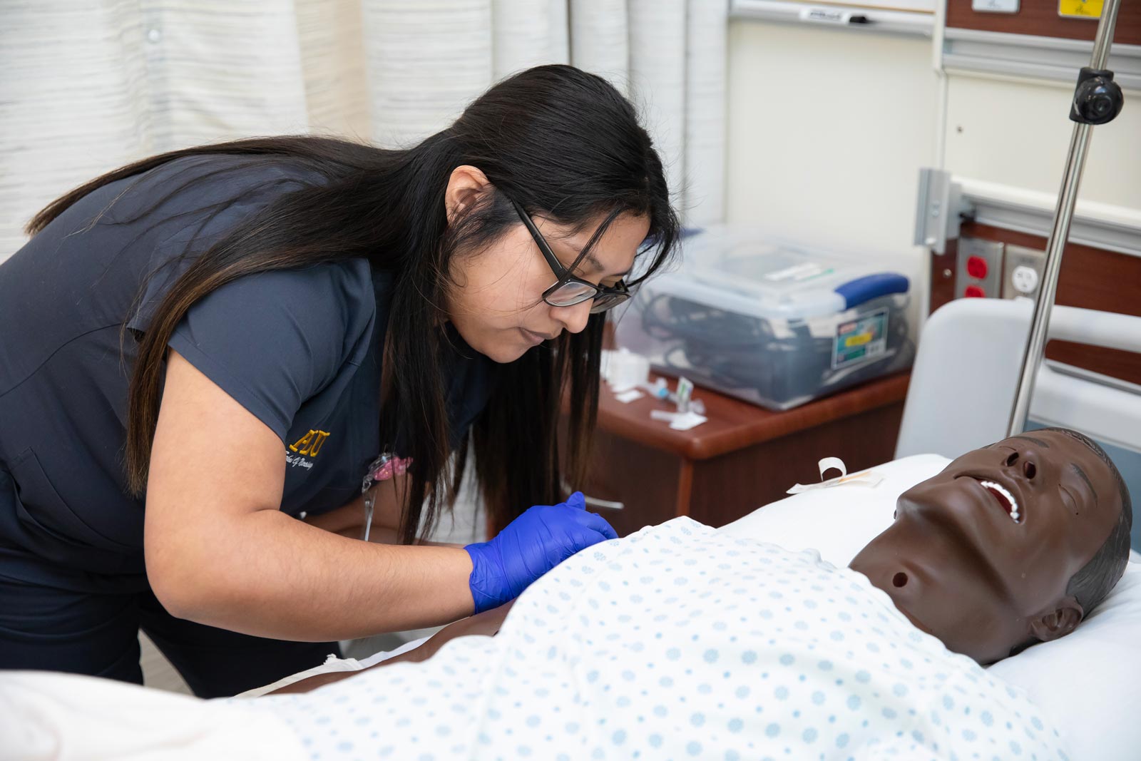 Clinical Instructor of Nursing Kristina Kenning leads the NURS 316 course titled “Clinical Practicum II Lab” which focuses on the practical application of core knowledge and competencies across the lifespan, Monday, March 4, 2024, at PLU. Students practice placing IVs and gravity drip bags. (PLU Photo / Sy Bean)