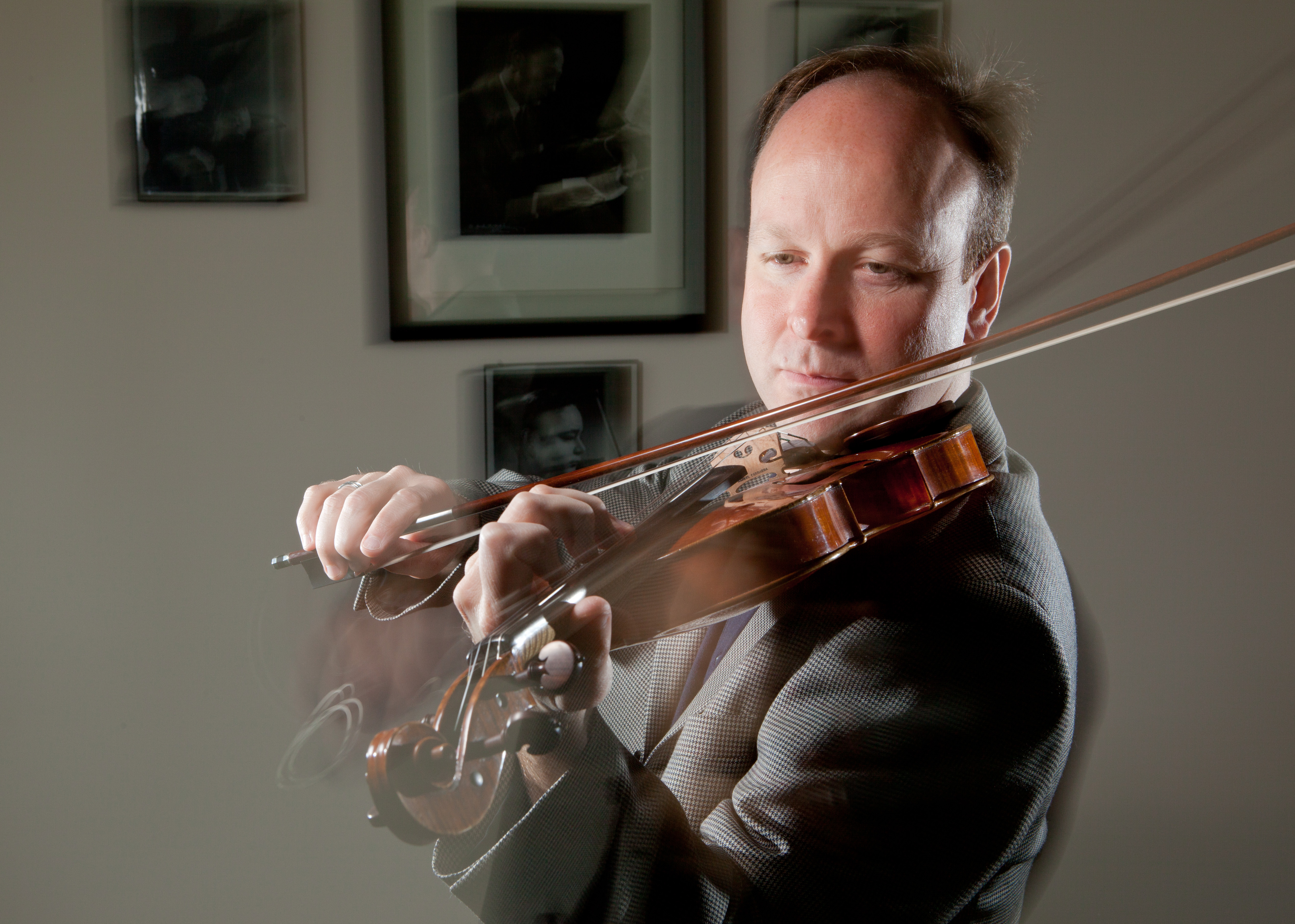 PLU Associate Professor of Music, Violin, Svend Ronning,in his office.