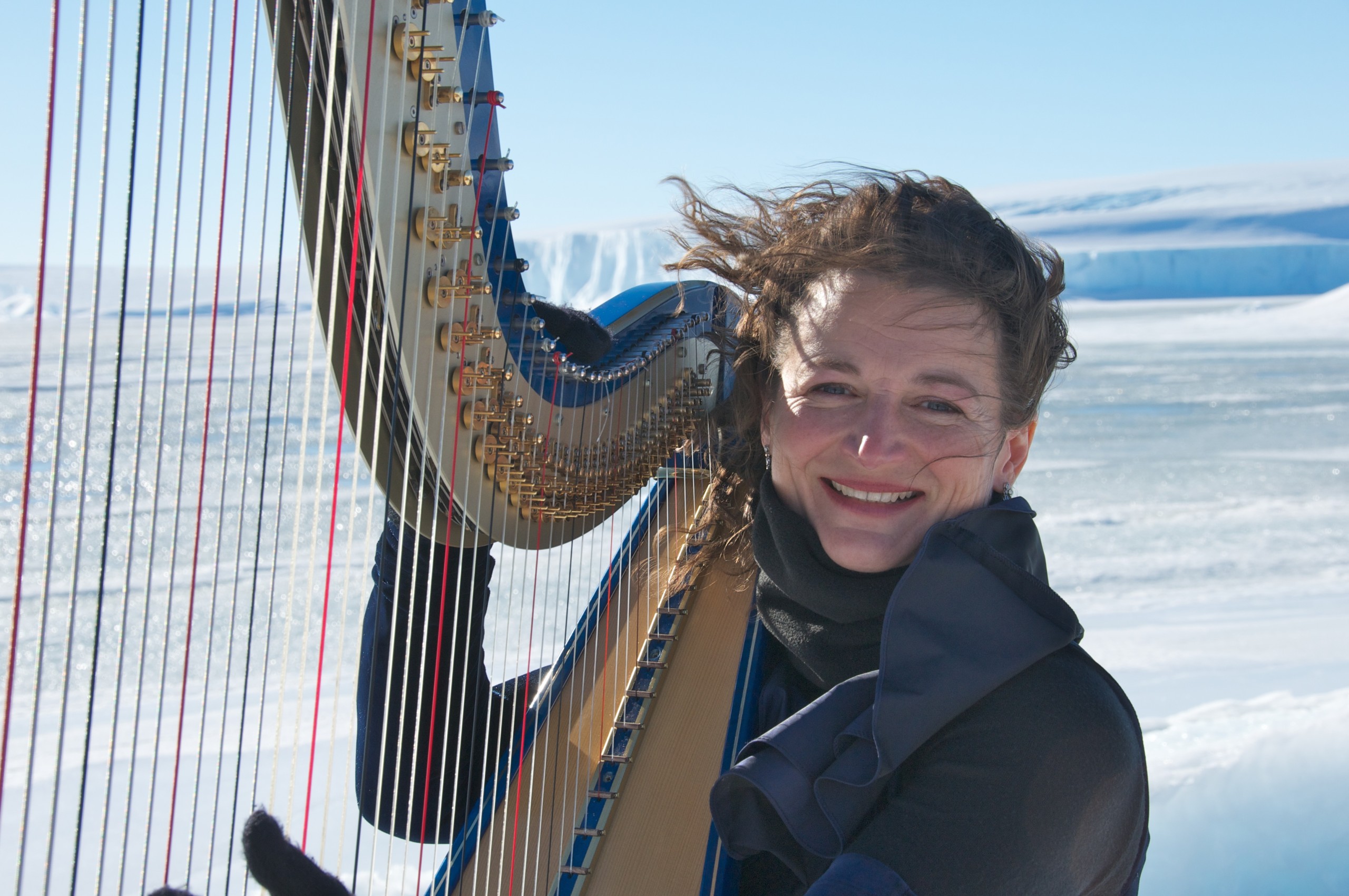 Alice Giles with her harp on snow