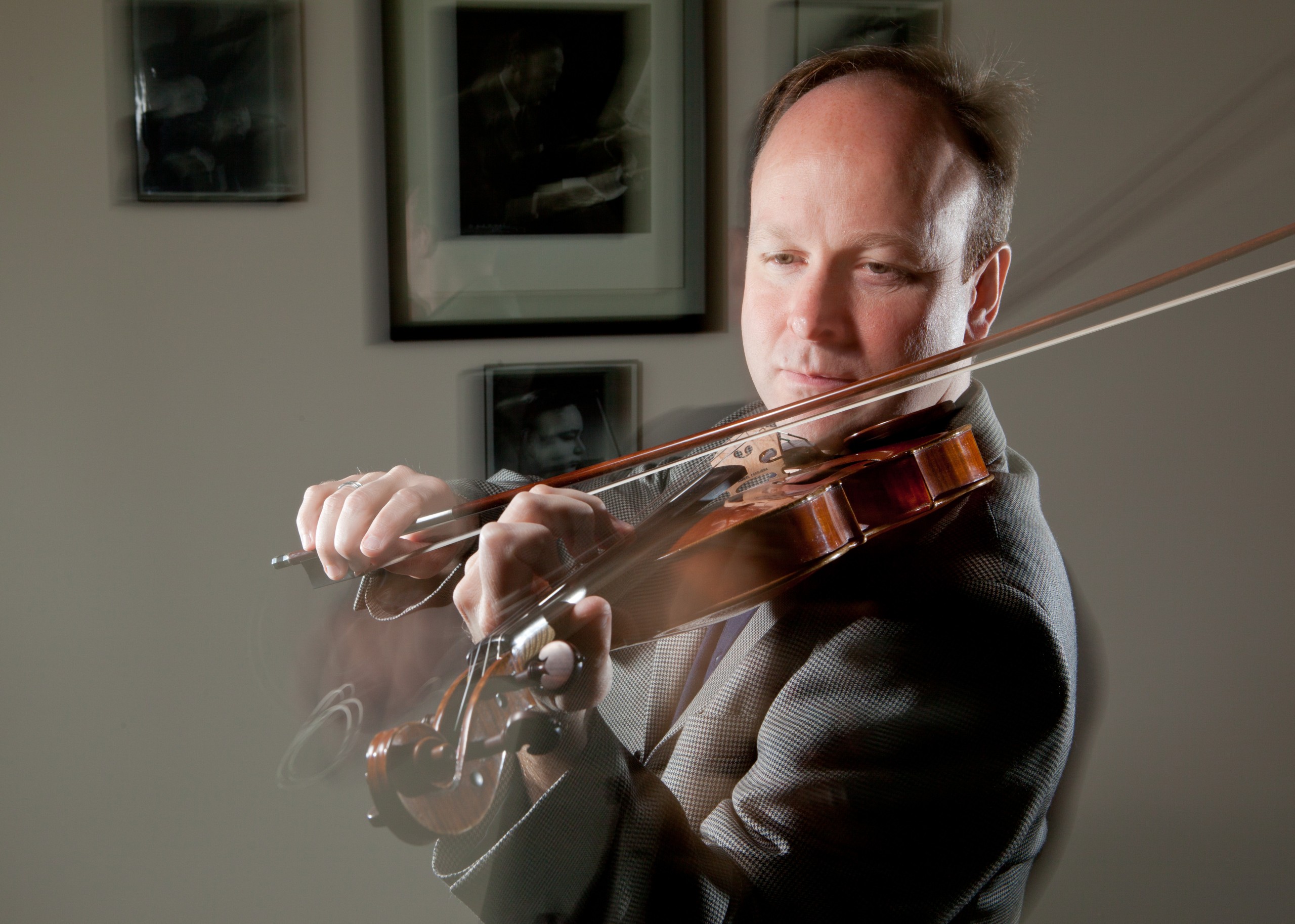 PLU Associate Professor of Music, Violin, Svend Ronning,in his office.