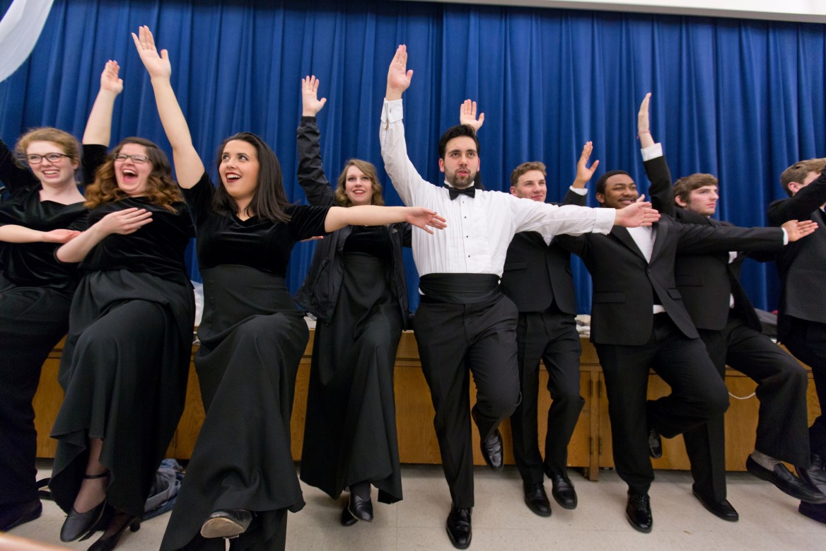 Students making a big L with their arms while practicing at the PLU Christmas 2015, 