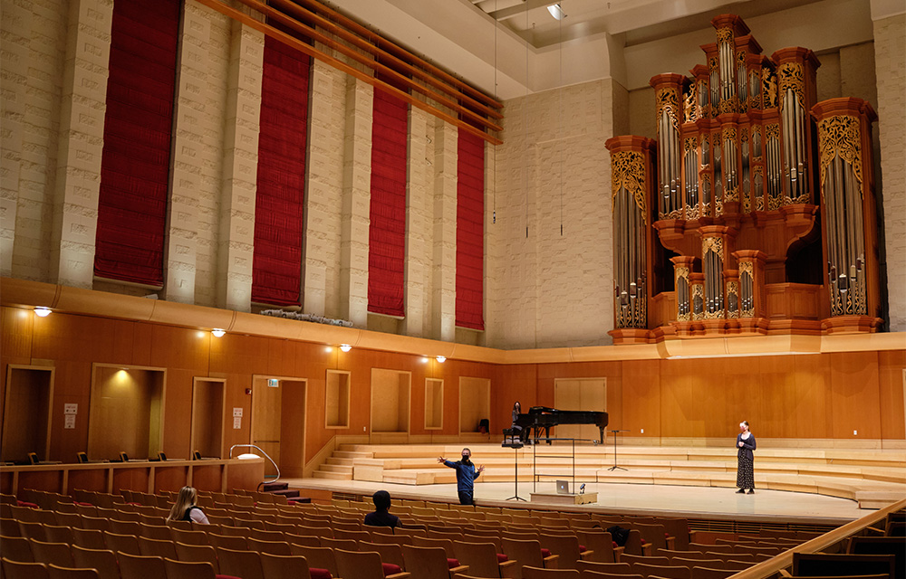 Dr. James Brown, in person, and Lee Anne Campos, virtually via laptop, conduct a socially distant vocal seminar with Maya Adams singing in Lagerquist Hall.