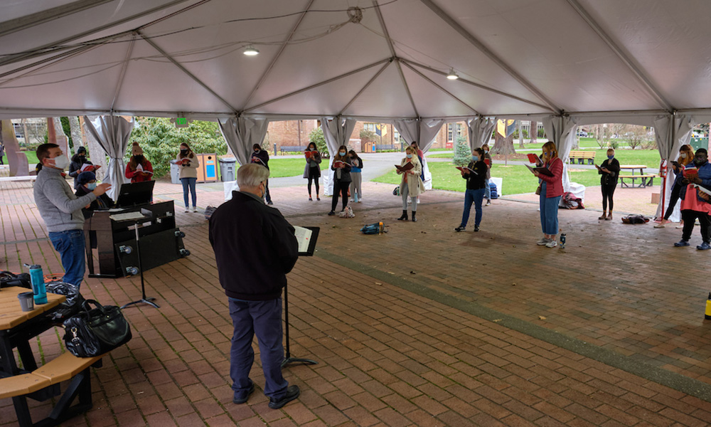 Students rehearse opera under the tent on Red Square that was erected for use during the COVID-19 pandemic, with Profs. Barry Johnson and James Brown teaching the class, Thursday, March 4, 2021, at PLU. The class is working on a production is Die Fledermaus by Johann Strauss to be performed on May 21st and 22nd in Red Square, or on the stage of KHP ifpermitted by then. (PLU Photo/John Froschauer)