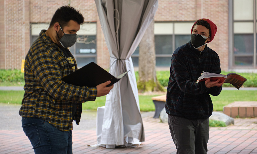 Two students rehearse opera under the tent in Red Square.