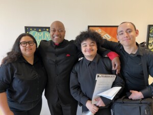 (Left to right) Meaghan Austin-Cortez, Conductor James E. Jackson, Sabien Kinchlow-McConnaughey, and Devin Bianchi-Rivera post for a photo