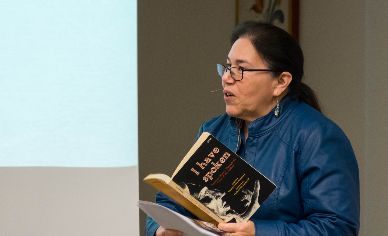 Woman speaking into microphone