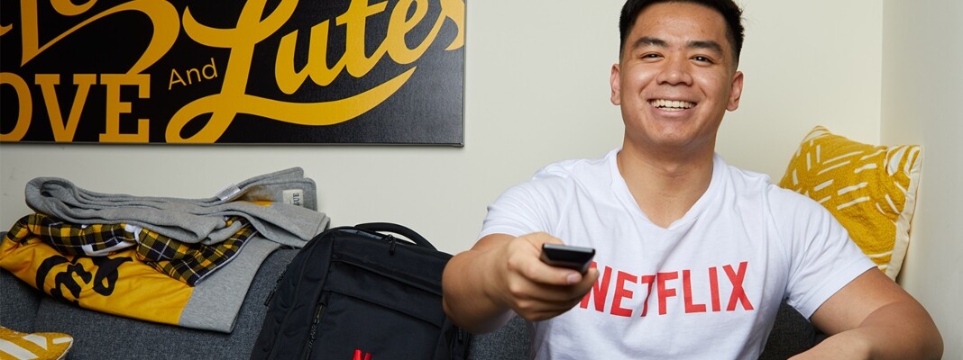 Adrian on couch wearing Netflix t-shirt
