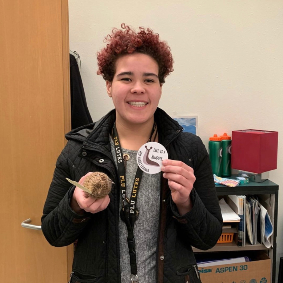 Student holding sticker of slug