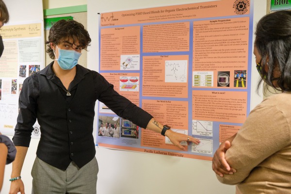 Student talking about their research using a poster