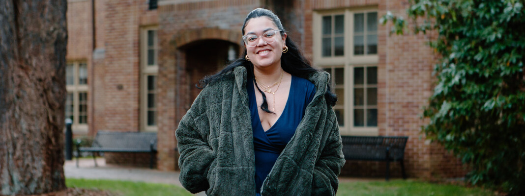Stephanie Aparicio Zambrano in front of Harstad Hall