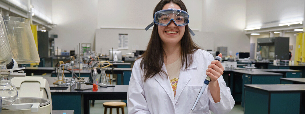 Student working with pipette in lab