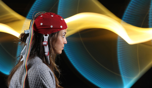 a student with a cap to measure brain waves