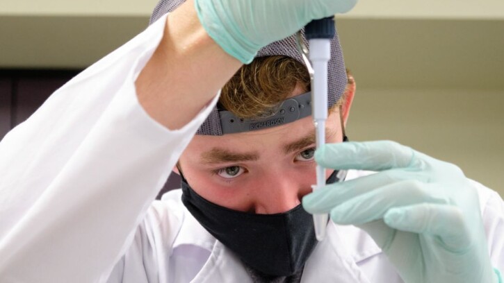 student works with a pipette