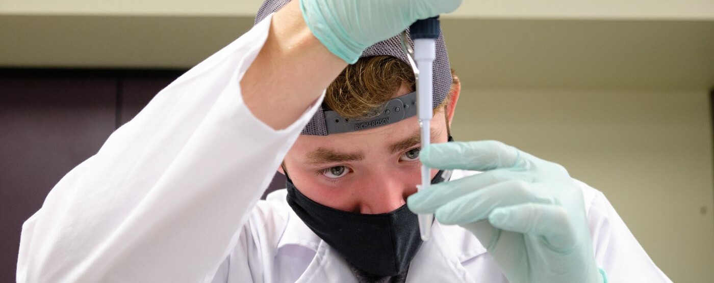 student works with a pipette