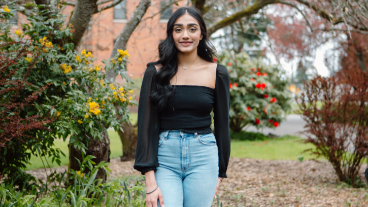 Jasneet Sandhu standing outside on campus.