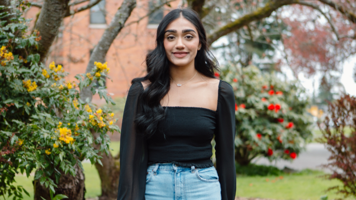 Jasneet Sandhu standing outside on campus.