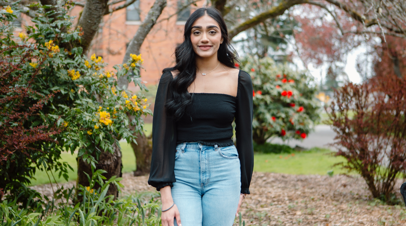 Jasneet Sandhu standing outside on campus.