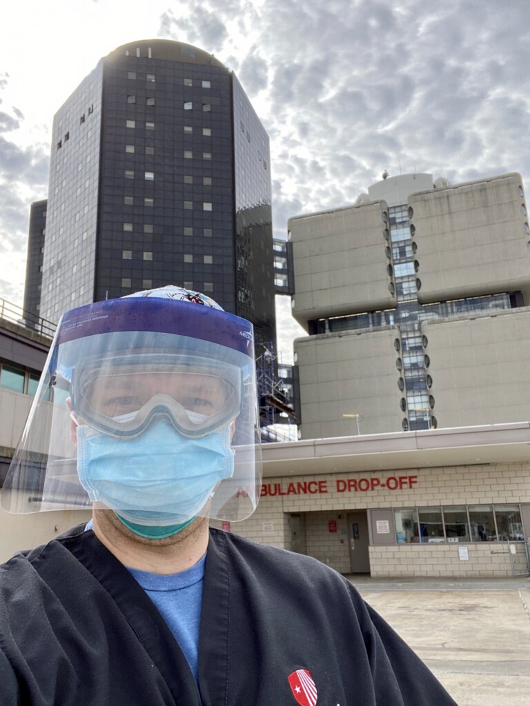 Sean Boaglio ’13, the academic chief resident in the Emergency Medicine Department at Stony Brook University Hospital, works to triage patients in large tents set up outside the hospital.