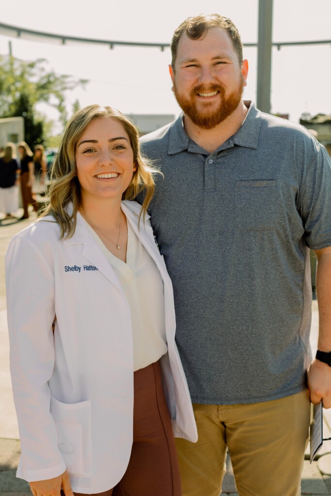 Shelby standing with her husband