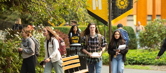 students walking on campus in the spring